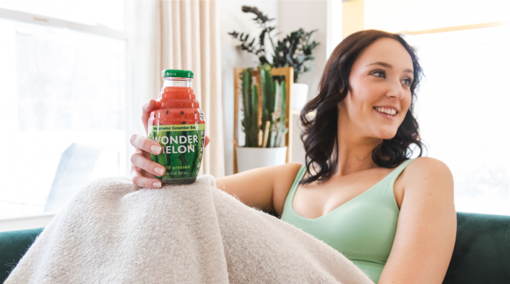 Woman with Wonder Melon Watermelon Cucumber Basil 100% organic cold-pressed juice