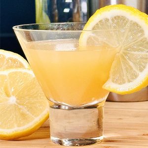 Lemon juice cocktail in a glass with fresh lemon slices.